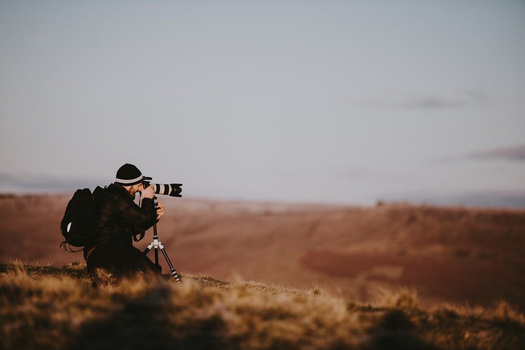 photographer behind camera lens